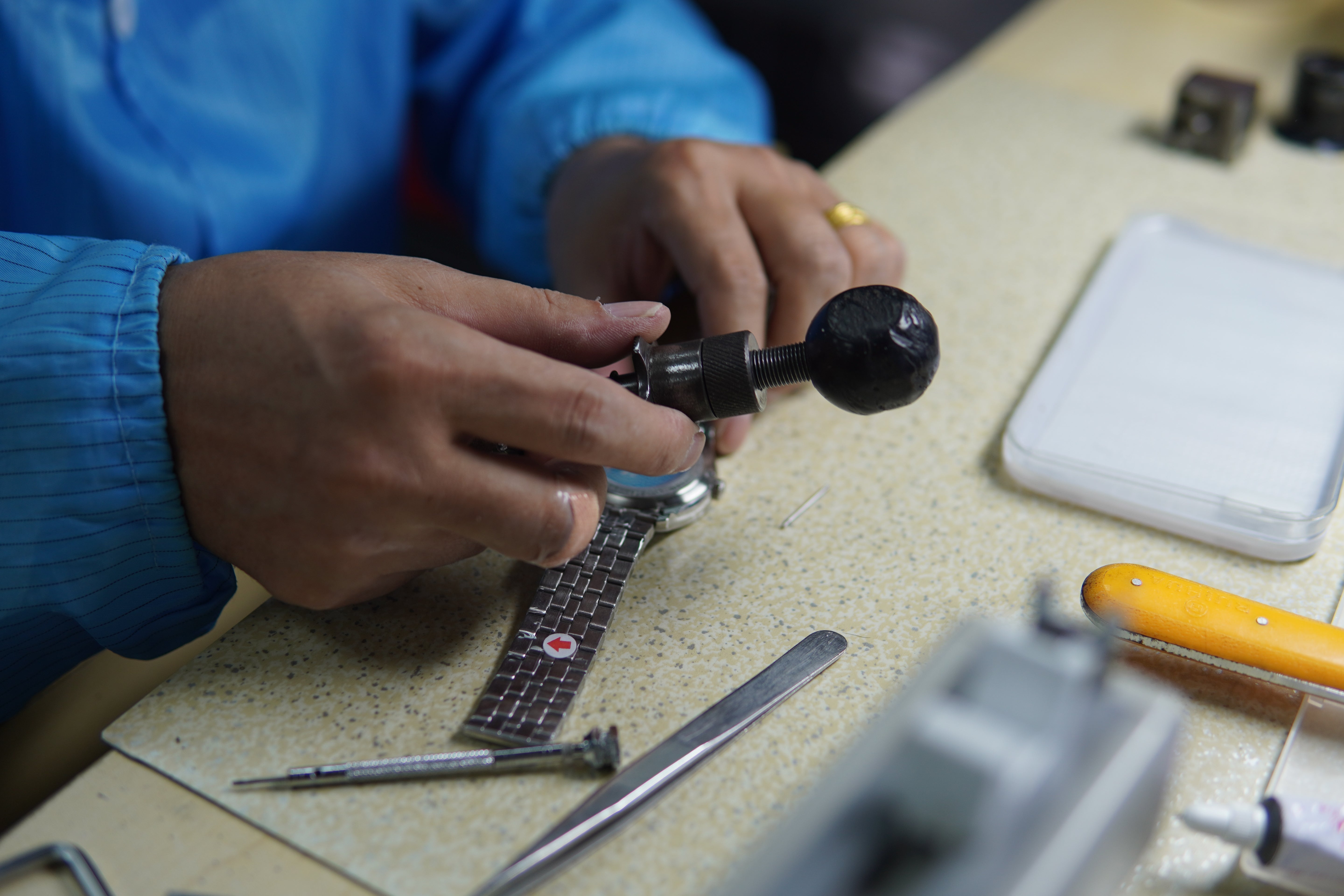 Watchmaker assembling a Daniel Gorman timepiece, showcasing precision craftsmanship and attention to detail in the production process.